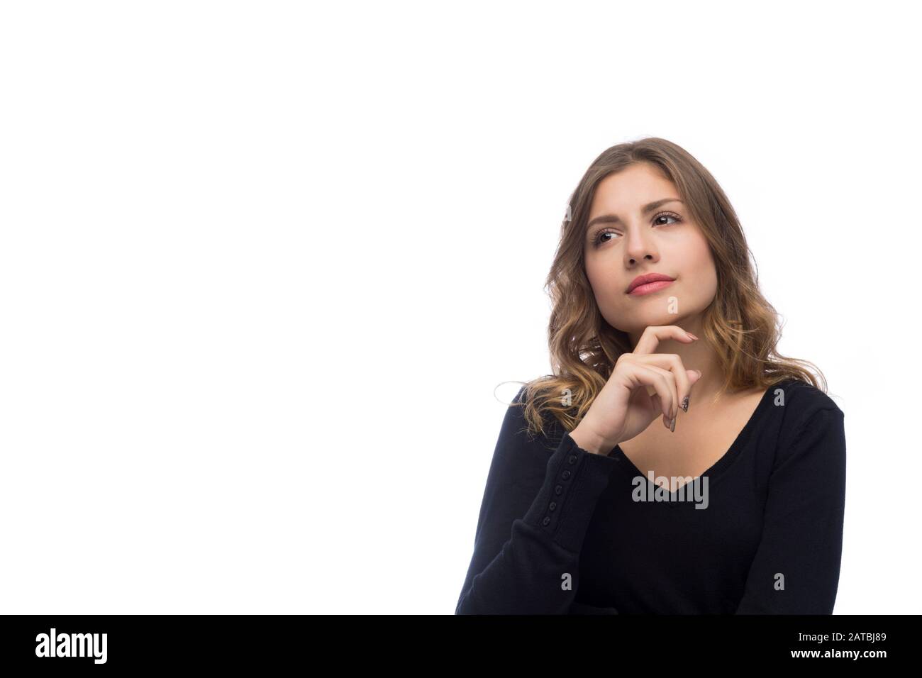 Beautiful young woman is thinking, isolated on white background Stock