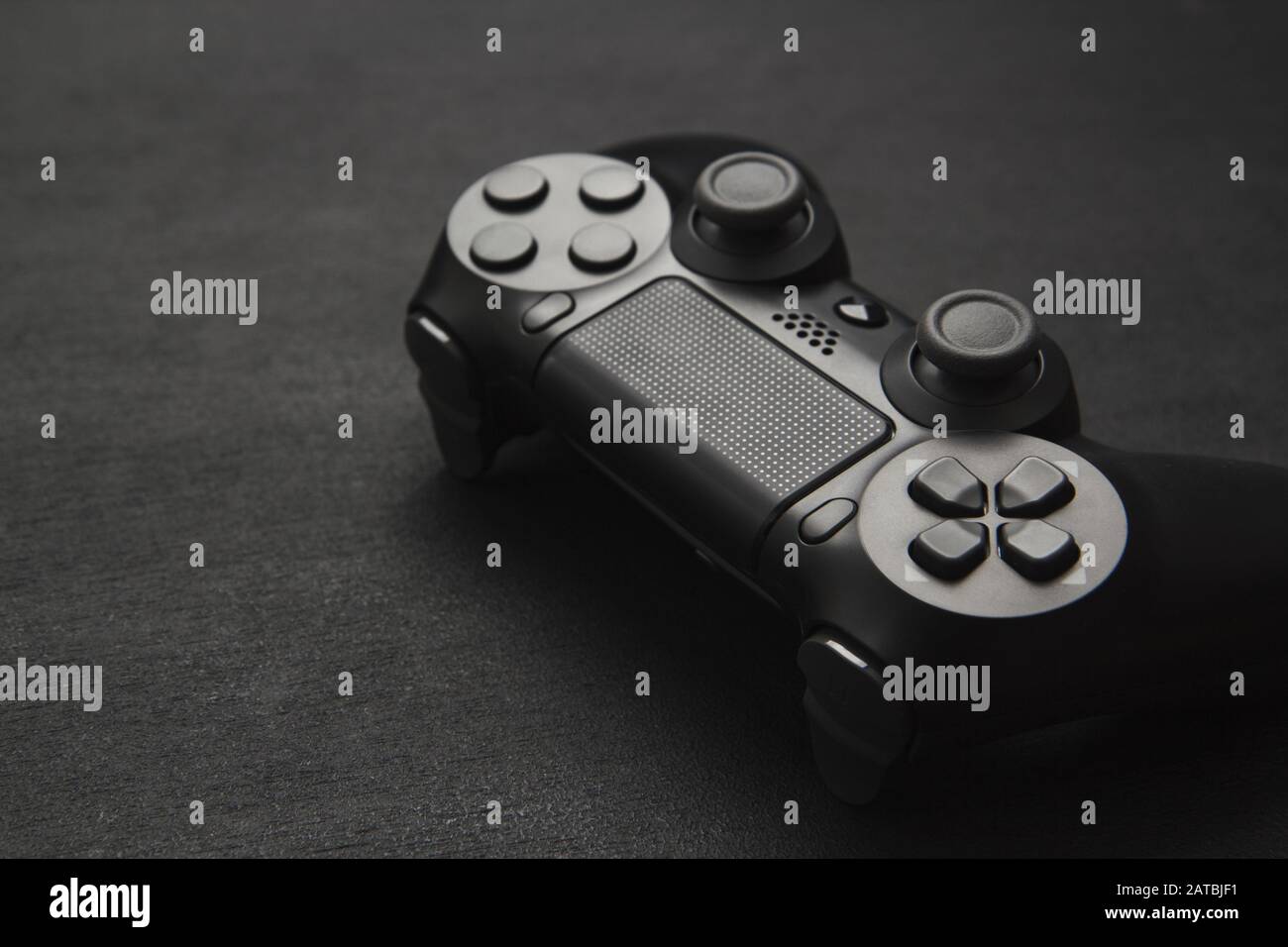 modern black wireless gamepad on a black background Stock Photo - Alamy