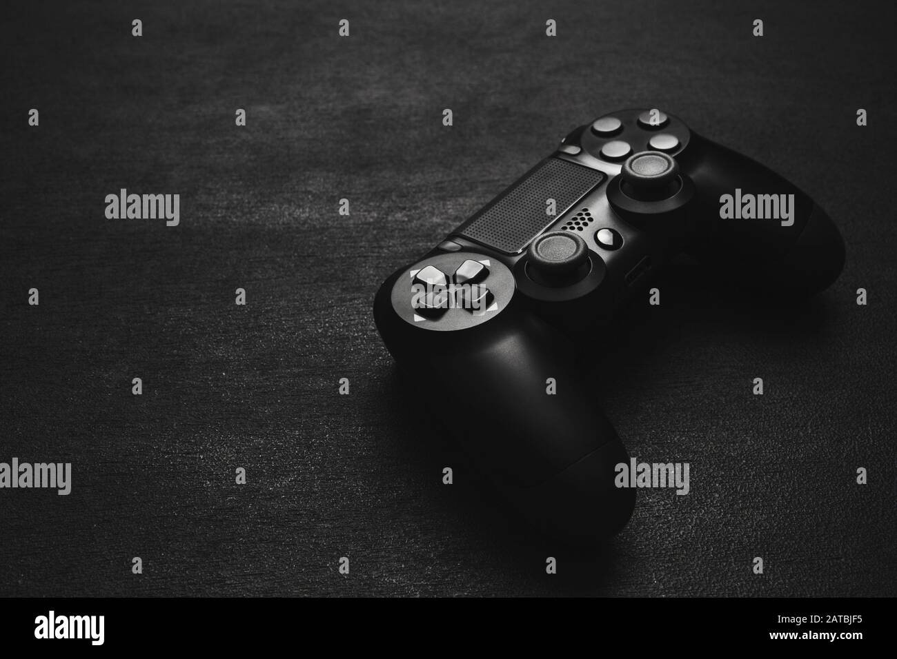 modern black wireless gamepad on a black background Stock Photo - Alamy