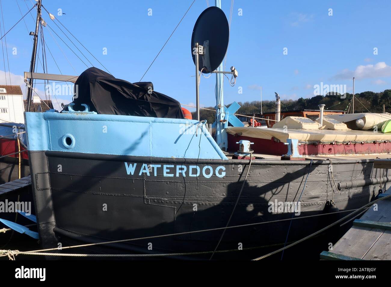 Woodbridge, Suffolk, UK - 1 February 2020: The Waterdog barge / houseboat moored up beside the River Deben. Stock Photo