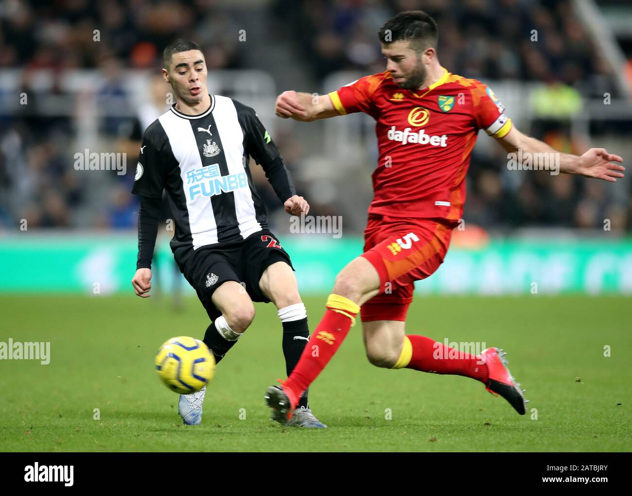 Newcastle United's Miguel Almiron (left) and Norwich City's Grant Hanley battle for the ball during the Premier League match at St James' Park, Newcastle. Stock Photo