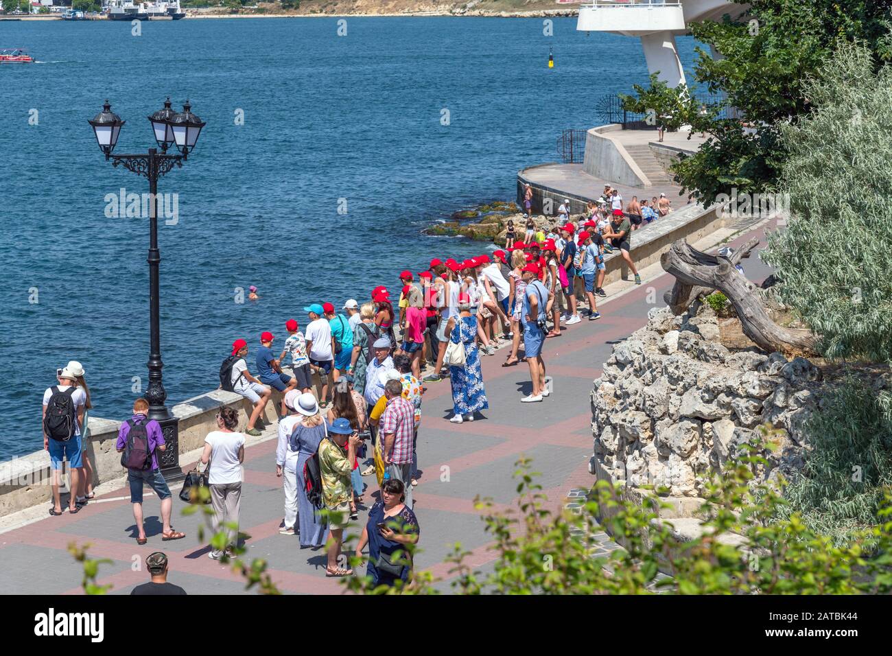 Sevastopol, Crimea - July 3, 2019. Tourist excursion group of children on the waterfront Stock Photo