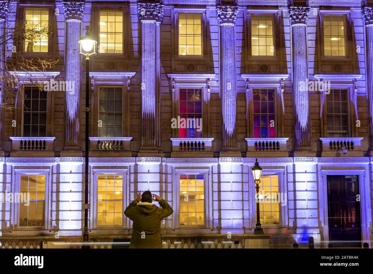 White projected onto the Cabinet Office in Whitehall for the Brexit Celebration on Brexit Day, 31 January 2020, in London, UK. Person photographing Stock Photo