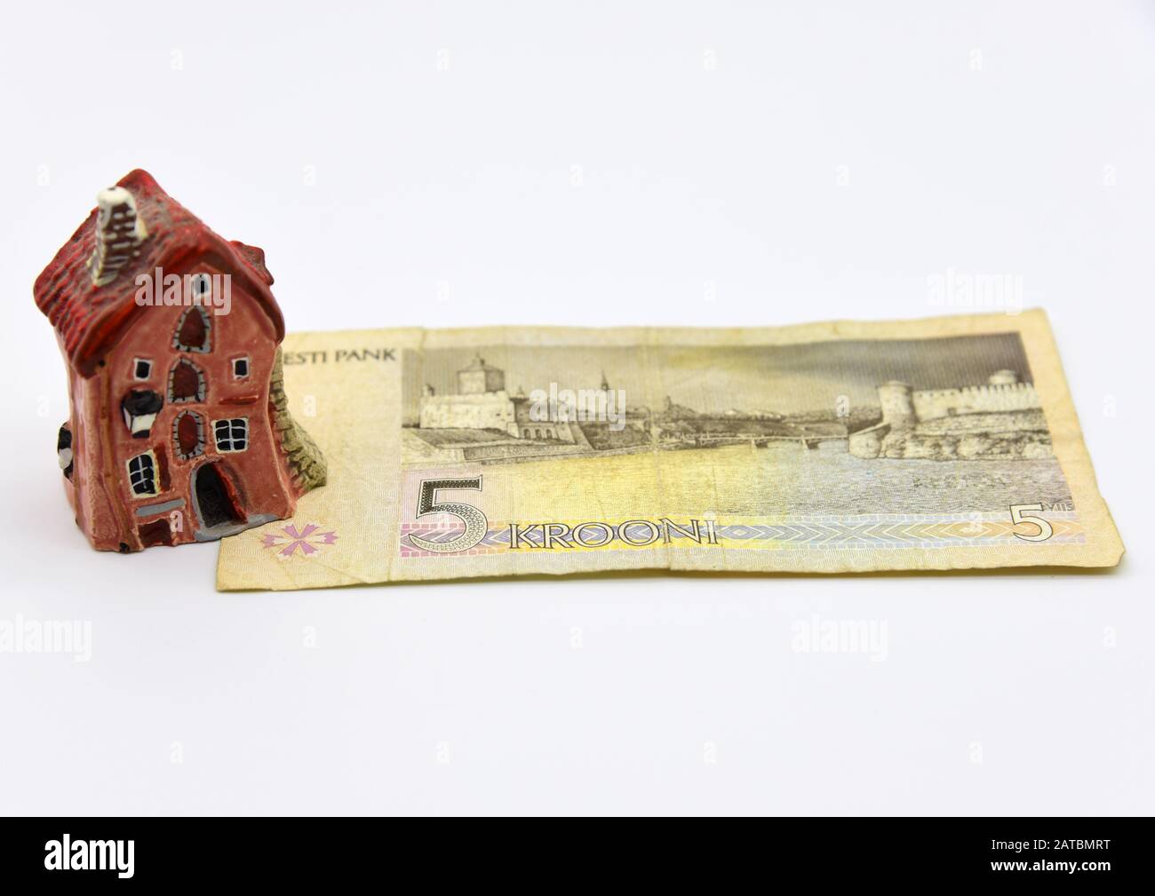 A small house stands on a disused Estonian five-kroner banknote. Stock Photo