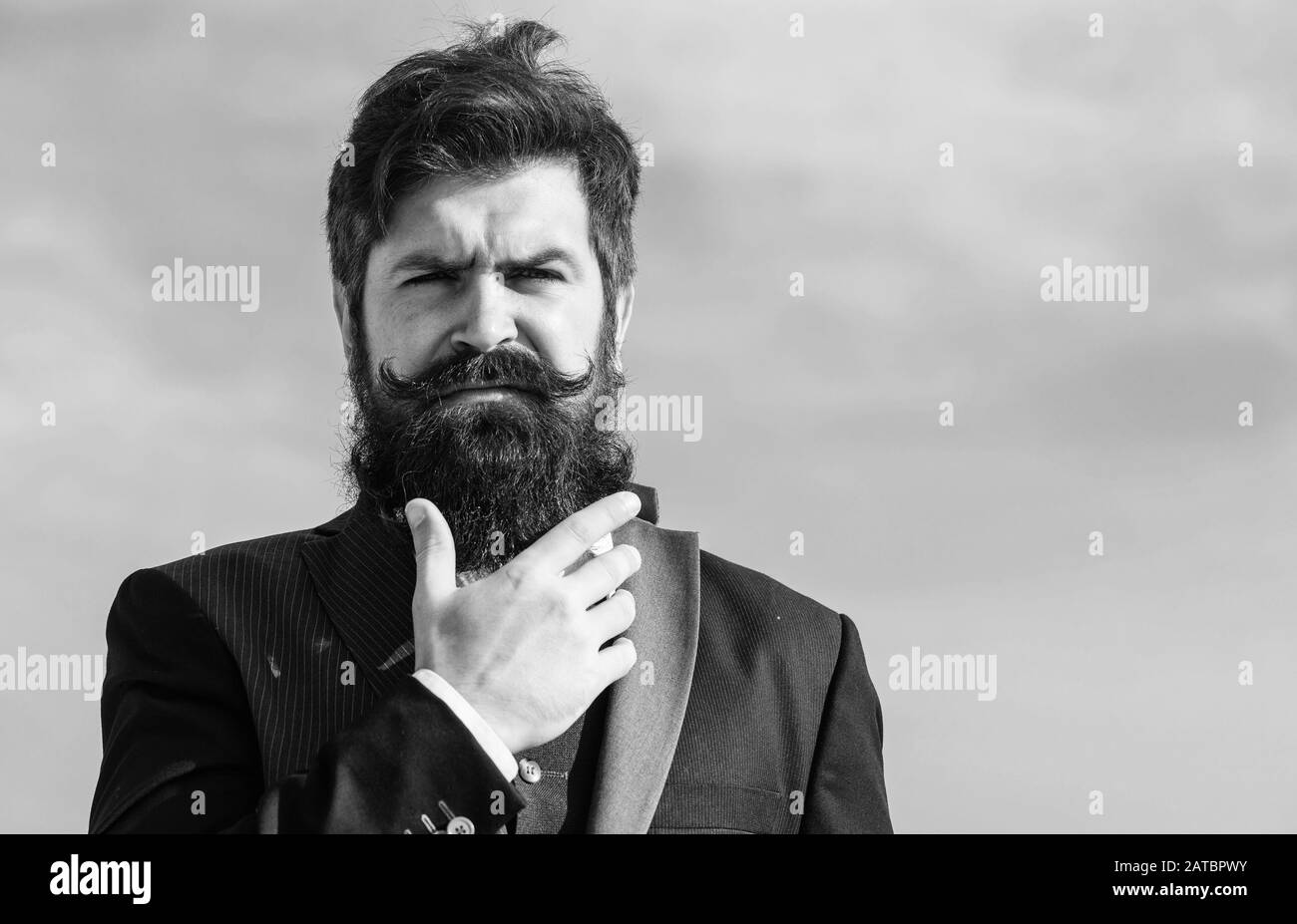 Facial hair beard and mustache care. Beard fashion trend. Invest in stylish  appearance. Grow thick beard fast. Man bearded hipster wear formal suit  blue sky background. Vintage style long beard Stock Photo -
