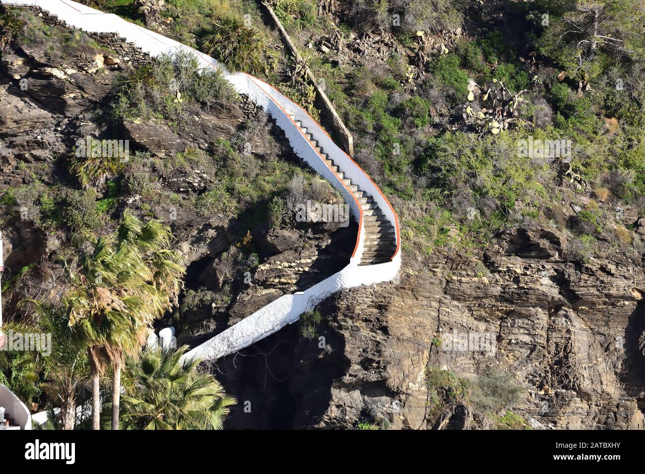 White Steep and winding stairs going up the mountain Stock Photo