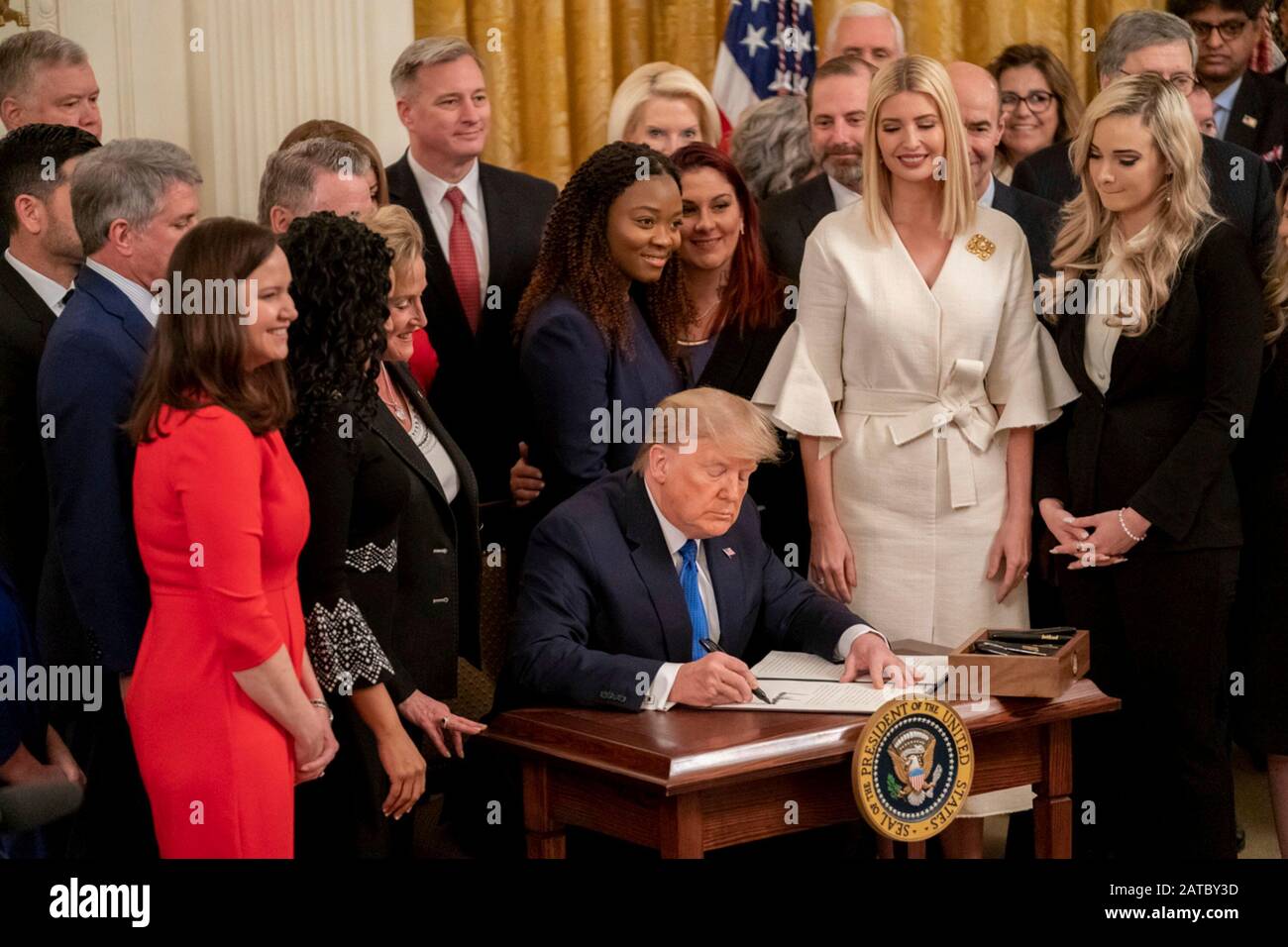 Washington, United States Of America. 31st Jan, 2020. Washington, United States of America. 31 January, 2020. U.S President Donald Trump, surrounded by survivors, officials and his daughter Ivanka Trump, right, signs an executive order to help combat human trafficking during a ceremony in the East Room of the White House January 31, 2020 in Washington, DC. The event took place following the White House Summit on Human Trafficking in honor of the 20th Anniversary of the Trafficking Victims Protection Act. Credit: Andrea Hanks/White House Photo/Alamy Live News Stock Photo