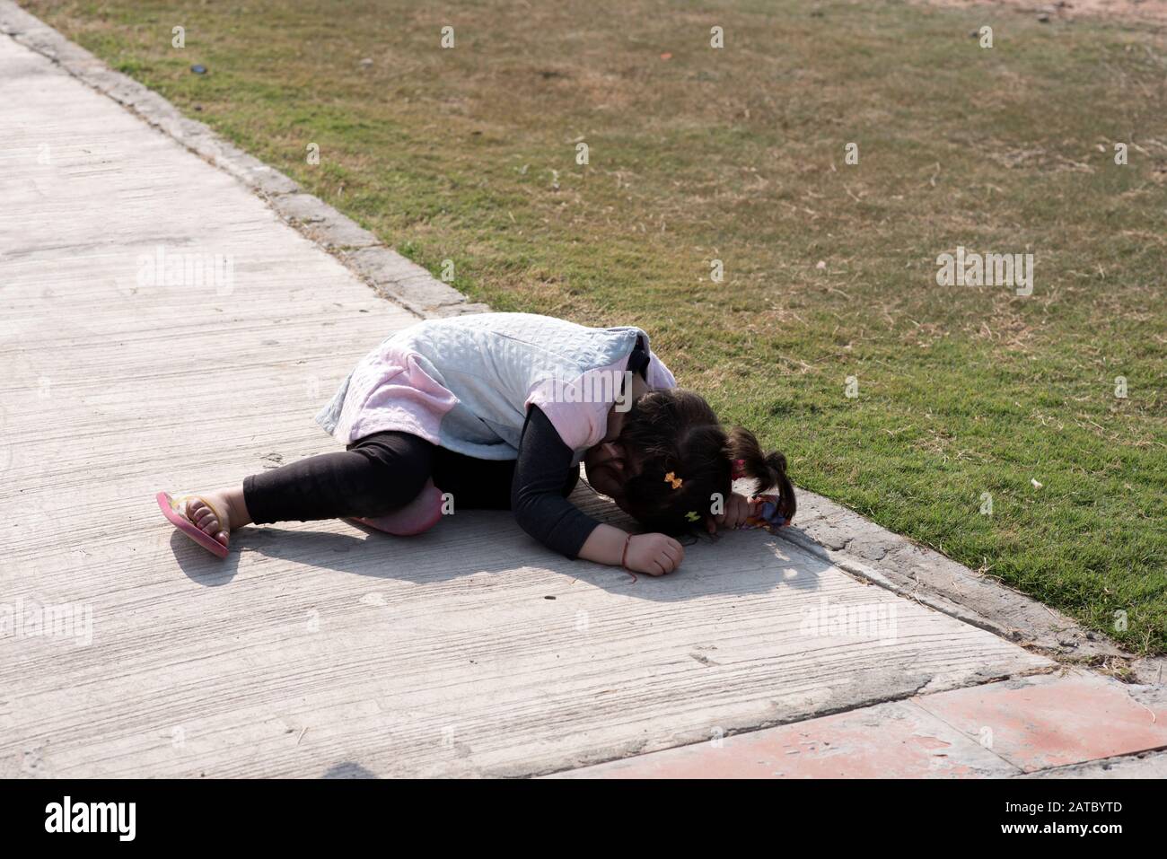 Little girl hiding her face in the ground. Stock Photo