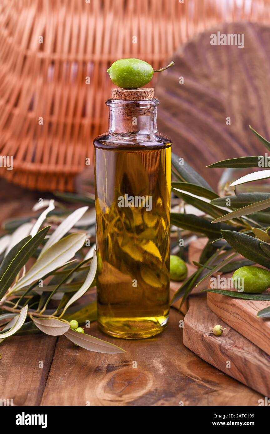 Green olives in tin cans with loaf of fresh bread and young olives