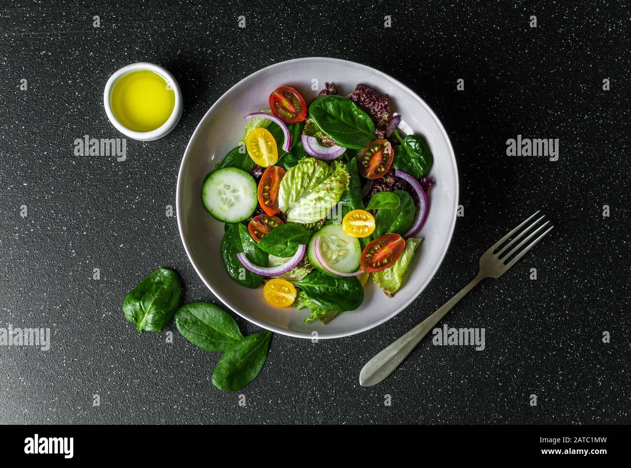 Top view of greens vegetable salad bowl with lettuce, spinach, and