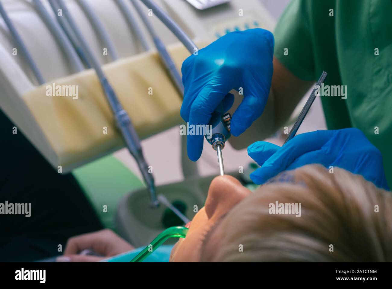 Female dentist with rubber gloves checking up the teeth of her patient