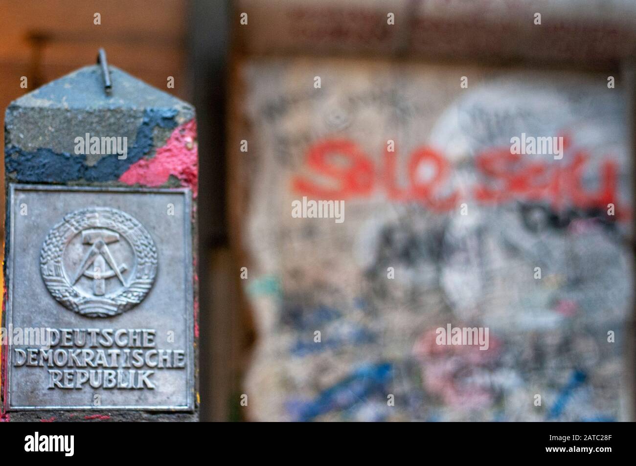 Piece of wall and Deutsche Demokratische Republik sign Friedrichstrasse Berlin Germany Stock Photo