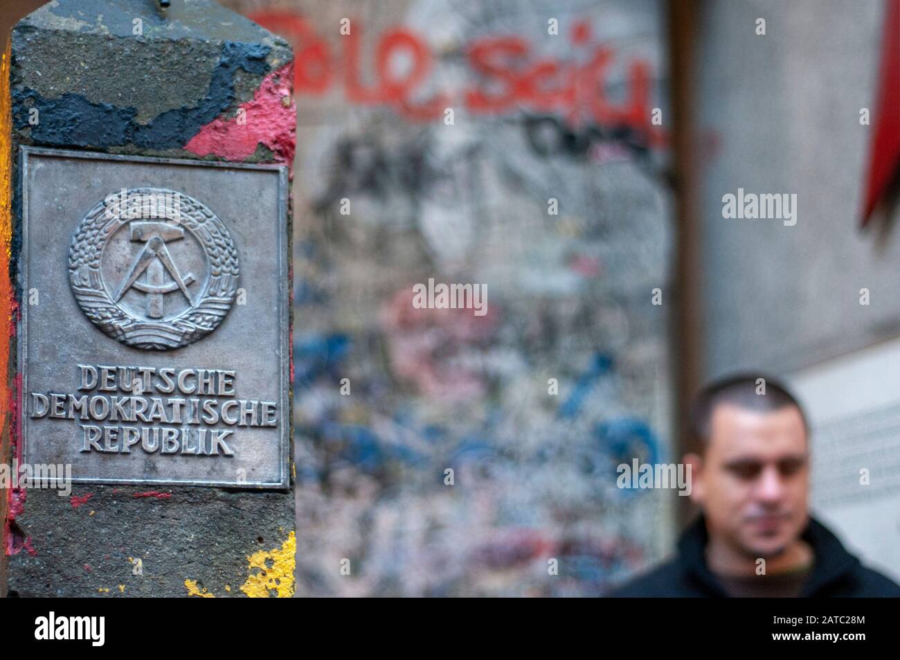 Piece of wall and Deutsche Demokratische Republik sign Friedrichstrasse Berlin Germany Stock Photo