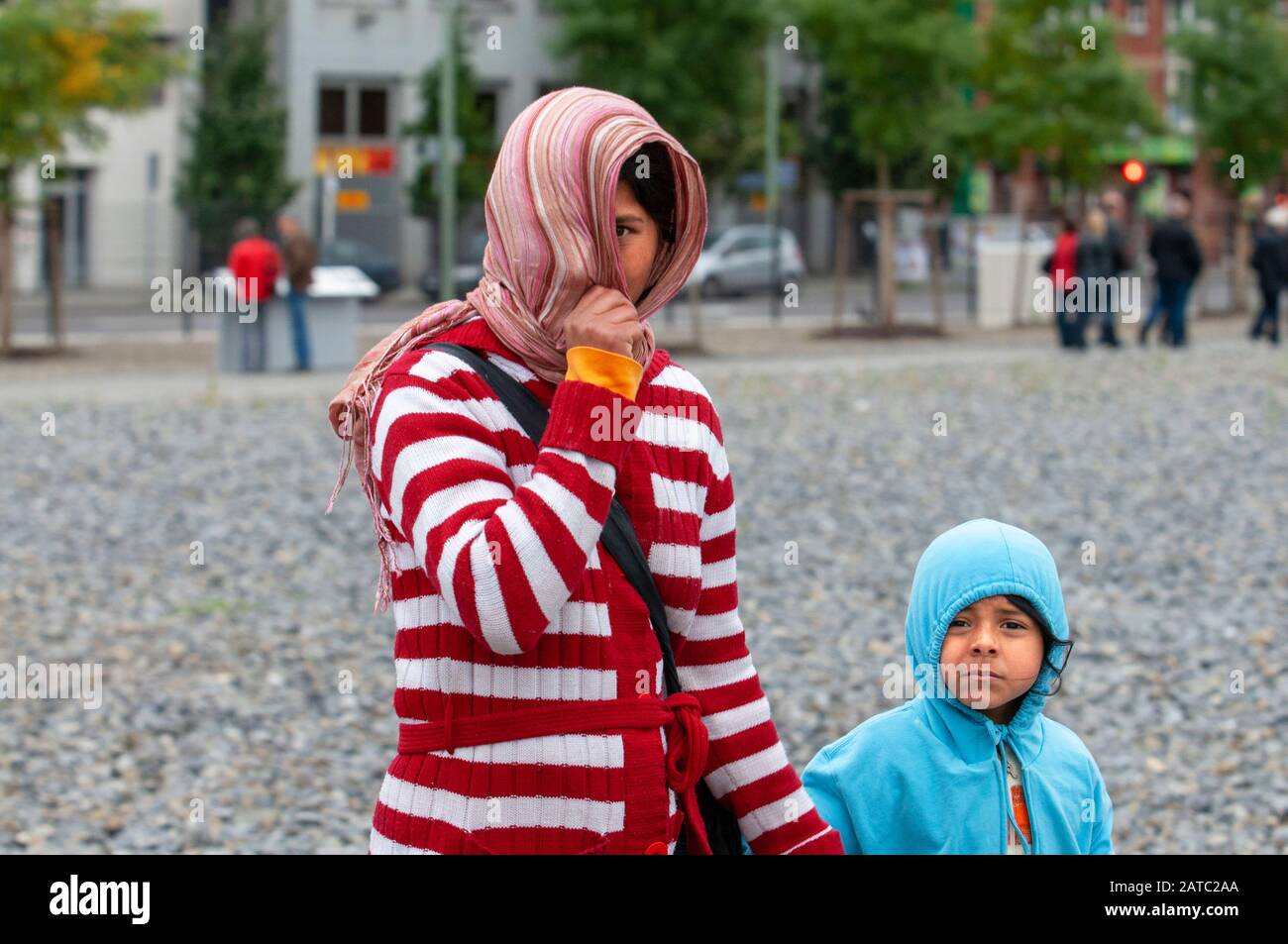 A poor Romanian gypsy mother with her young son in the center of Berlin Germany Stock Photo