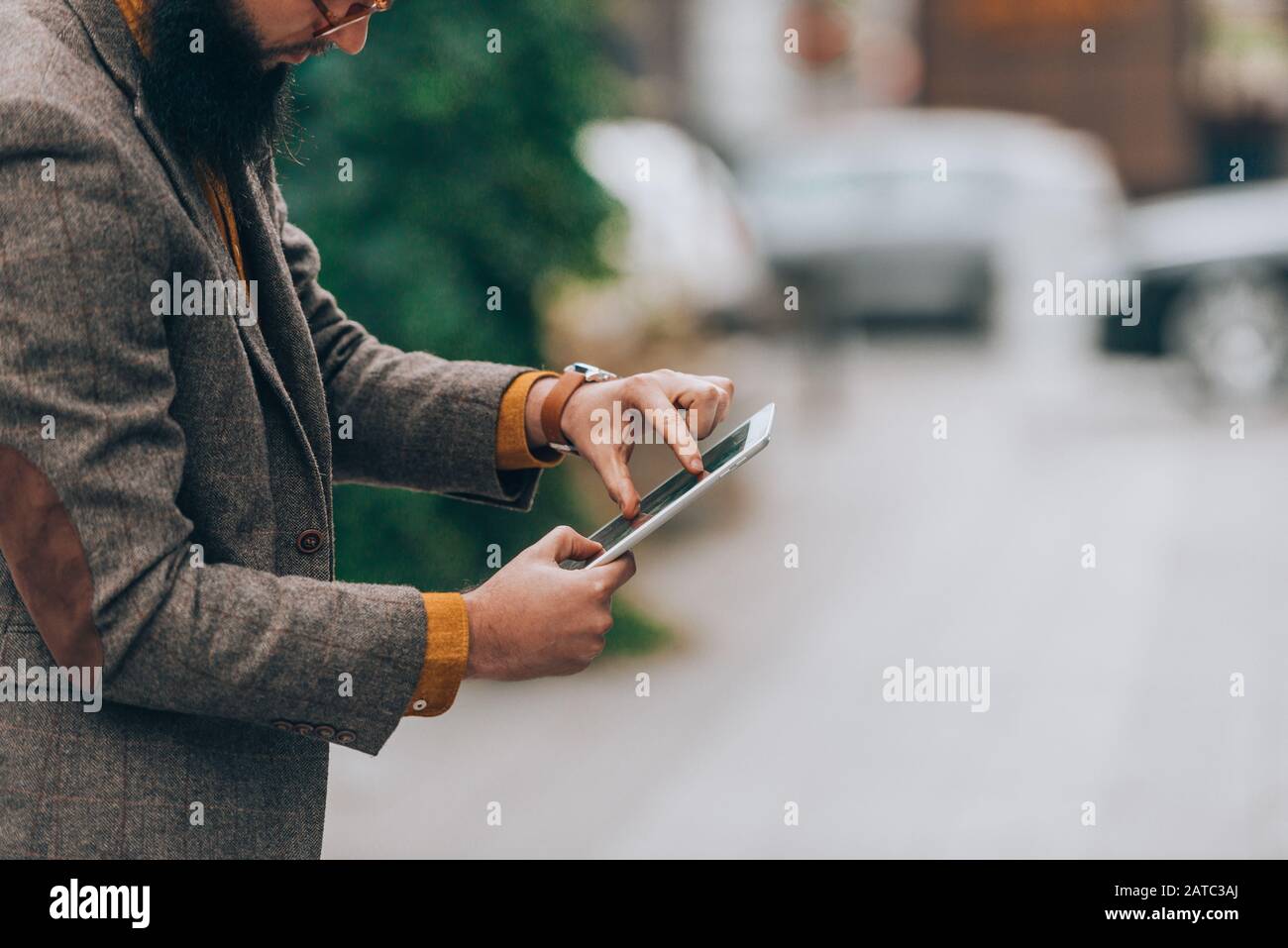Modern day young businessman checking his e-mail on a tablet computer Stock Photo