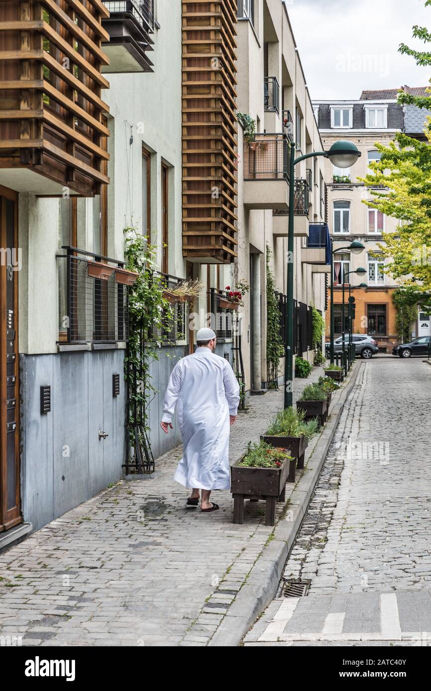 Brussels Old Town / Belgium - 06 07 2019: Moroccan man in traditional white Djellabah clothes walking through the Streets of Brussels Old Town Stock Photo