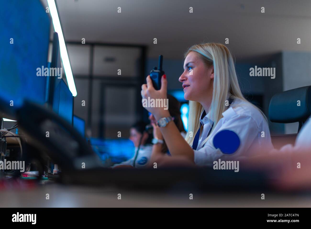 Happy security data center operator colleagues (coworkers) smiling and ...