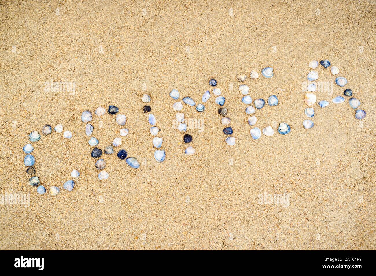 'Crimea' built of sea shells on sand of the Crimea coast, Russia. Inscription with seashells on the beach in Southern Crimea. Concept of summer vacati Stock Photo