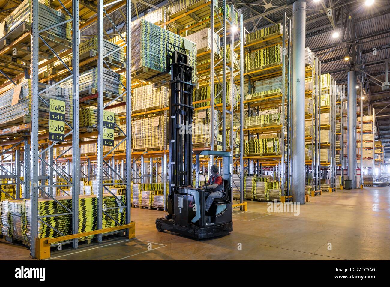 Moscow - August 1, 2017: The worker loads goods in a large warehouse. Moscow is a modern city with well-developed logistics infrastructure. Stock Photo