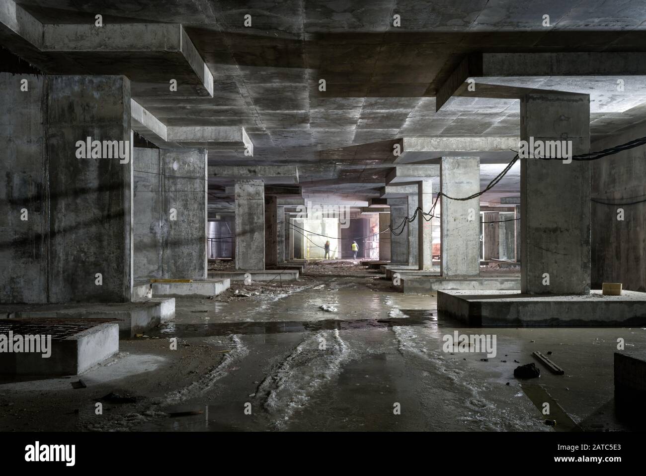 Concrete construction of underground level of building. Panorama inside the modern construction site in dark. Contemporary structure under constructio Stock Photo
