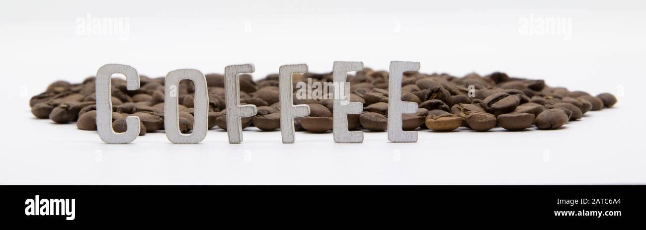 Coffee written in wooden letters and coffee beans isolated on white background Stock Photo
