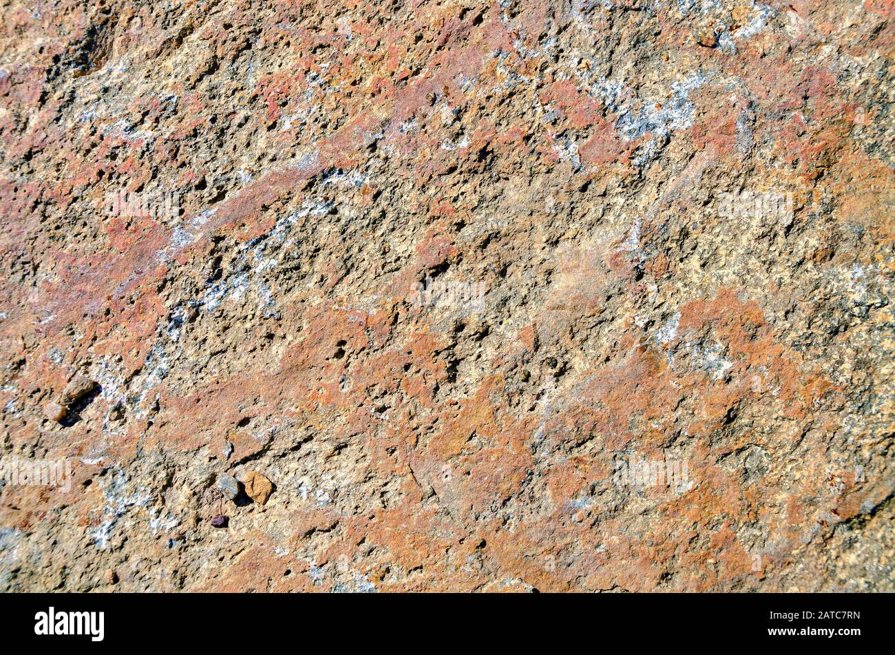 rough surface of a red and brown patterned granite rock Stock Photo - Alamy