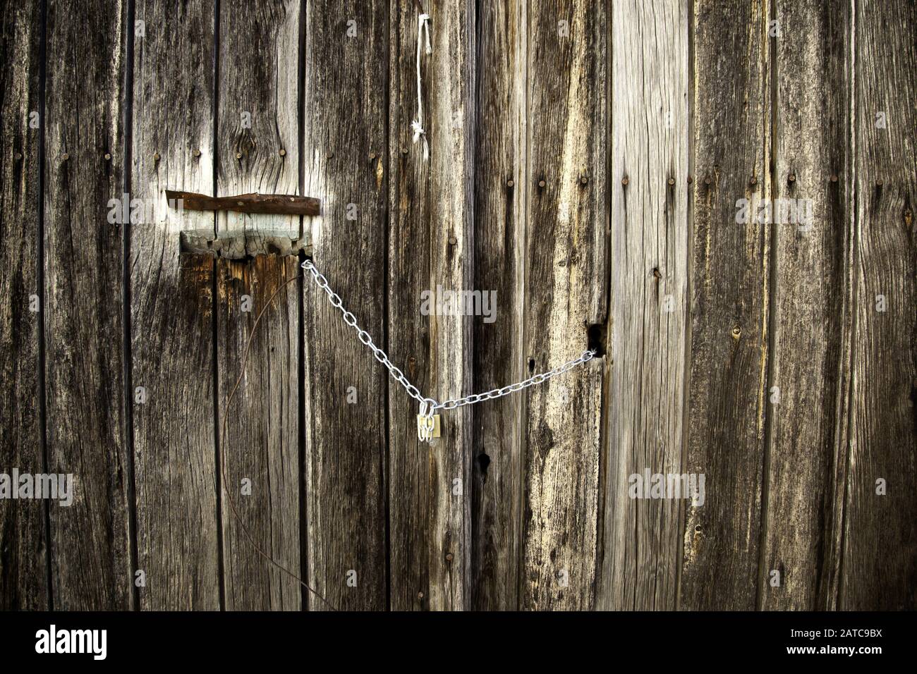 Broken wooden door with padlock, construction and architecture Stock Photo