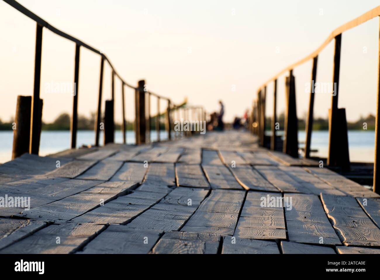 Boardwalk bridge over the lake in the morning sun Stock Photo