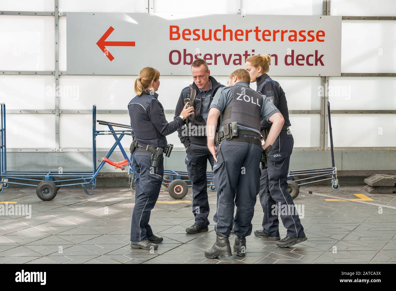 BERLIN, GERMANY - APRIL 20, 2019: German customs patrol with big ZOLL letters on uniform in Tegel airport. Berlin is the capital and largest city of G Stock Photo