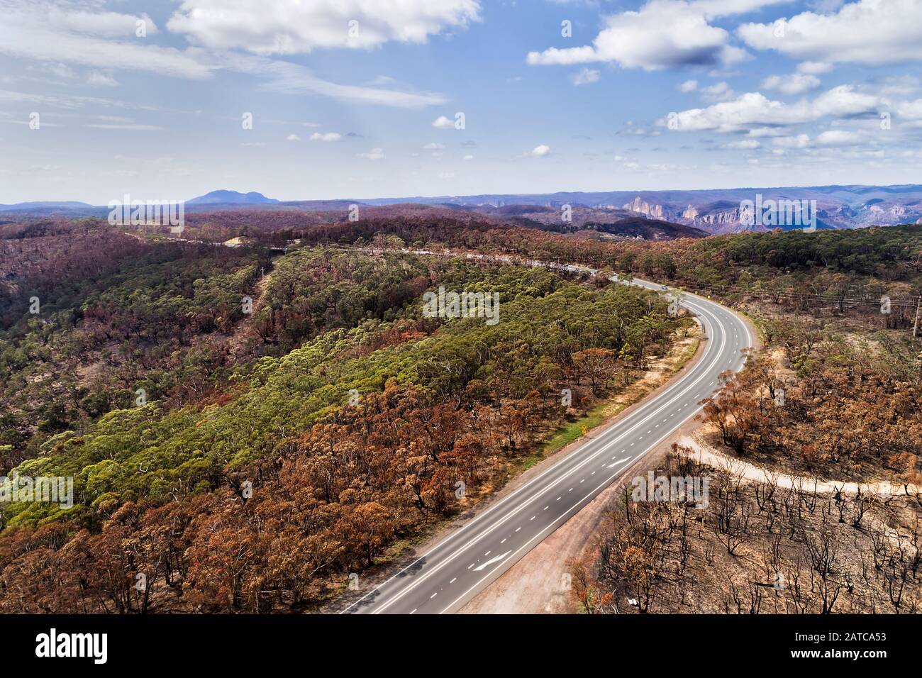 Bells line of road in BLue Mountains of Australia going through devastated areas of gum-tree forests after heavy bushfires with burnt woods. Stock Photo