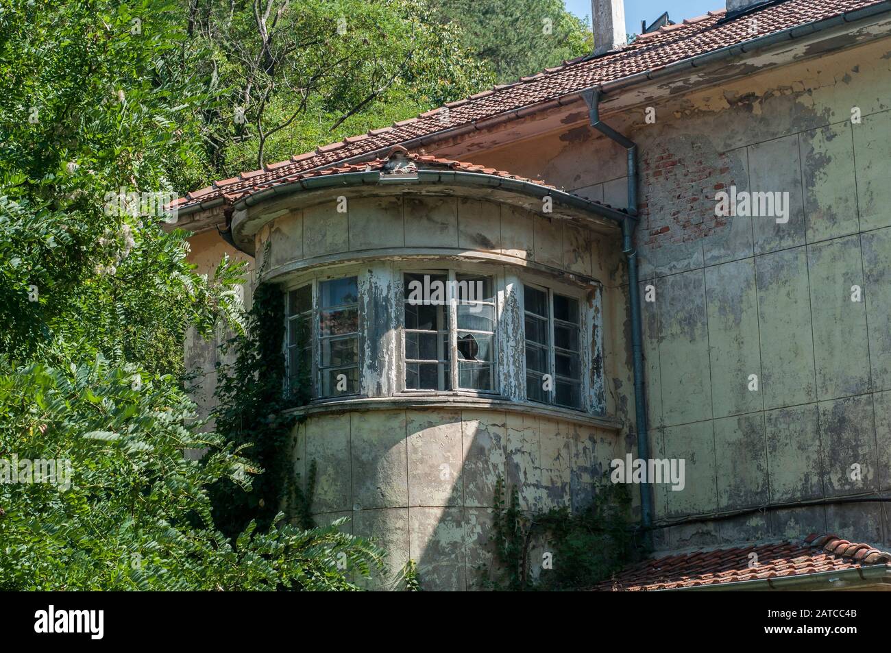 Old obsolete industrial building facade with broken windows Stock Photo