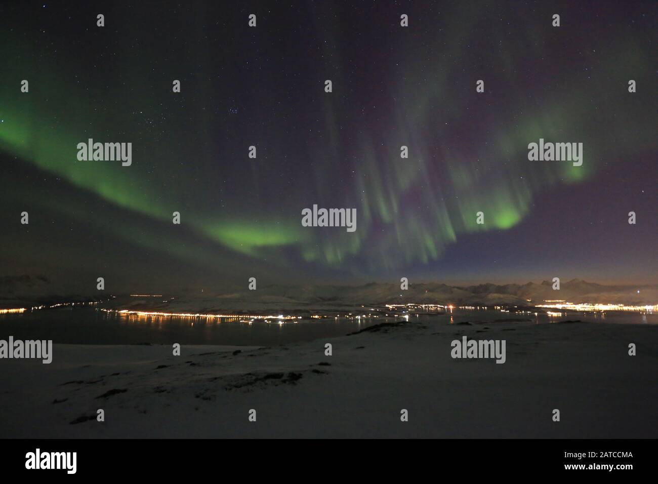 Northern Lights Over Winter Mountains Stock Photo