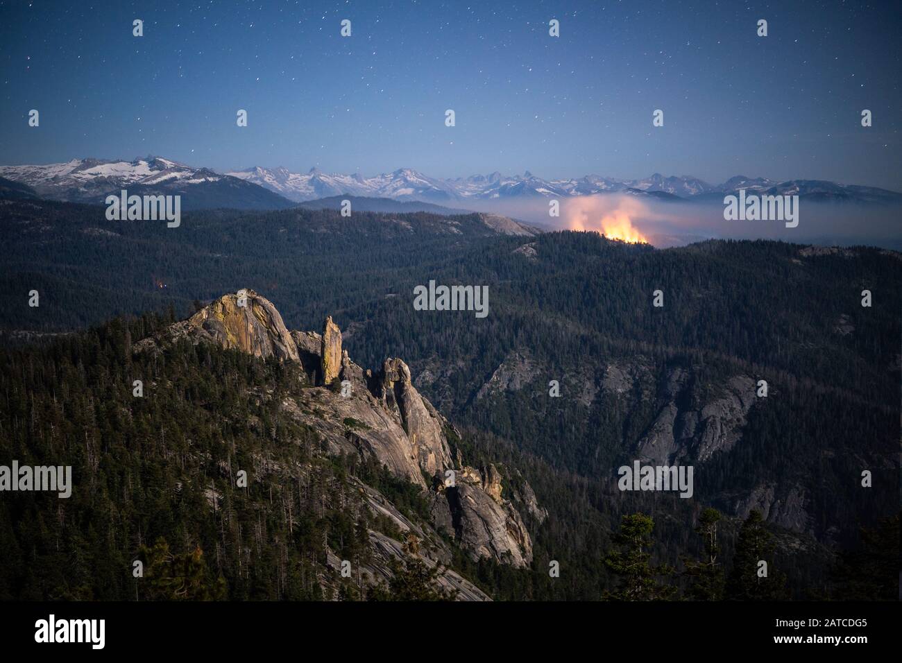 Controlled forest fire Burning behind Chimney rock, Sequoia National Park, California, USA Stock Photo