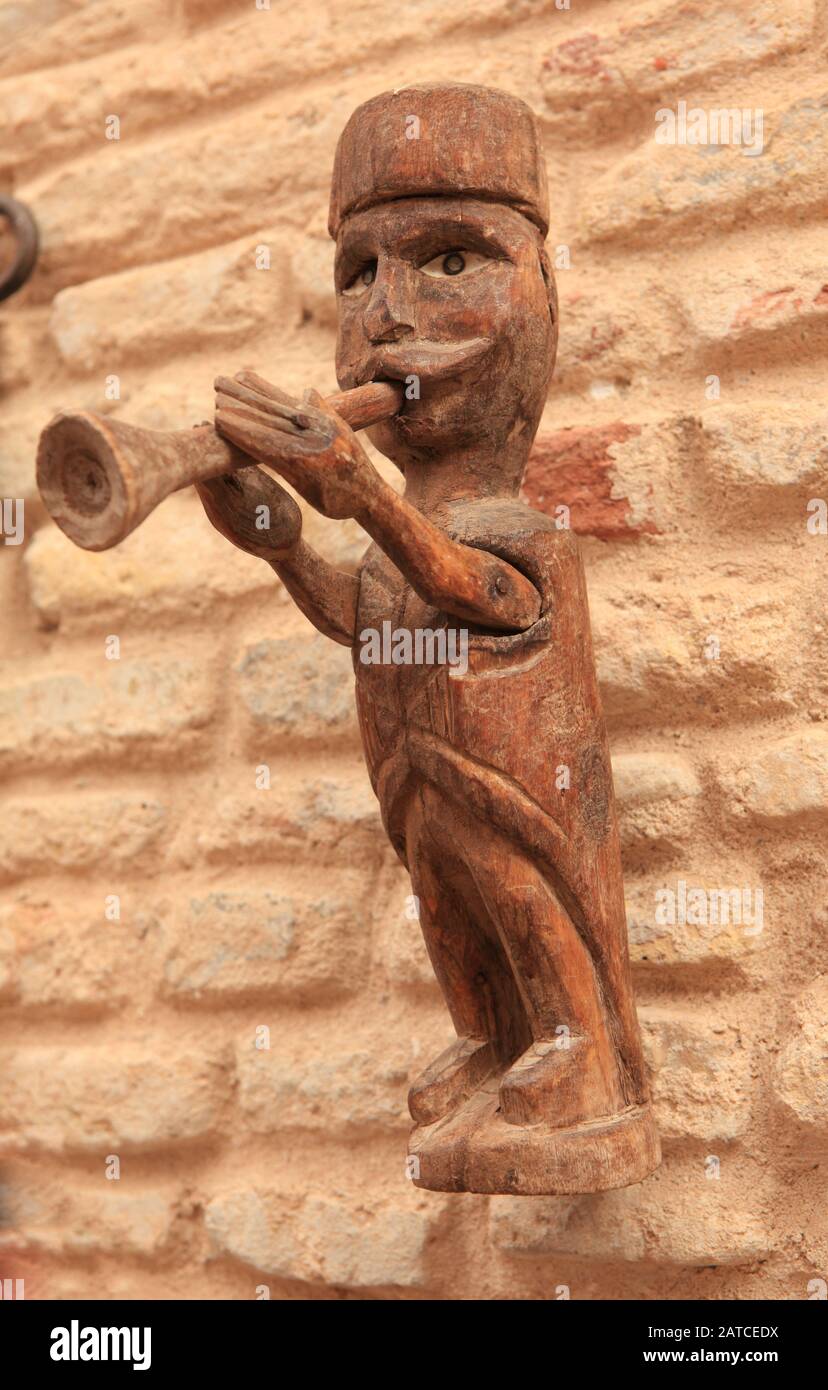 Local art. Miniature hand made statue for sale on the alley wall Stock