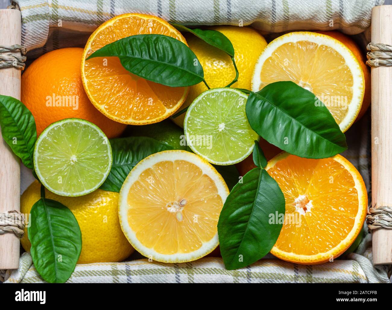 Sliced citrus in a basket. Flat lay. Juicy ripe slices of orange, lemon and lime. Fruit mix, top view. Food background. Stock Photo