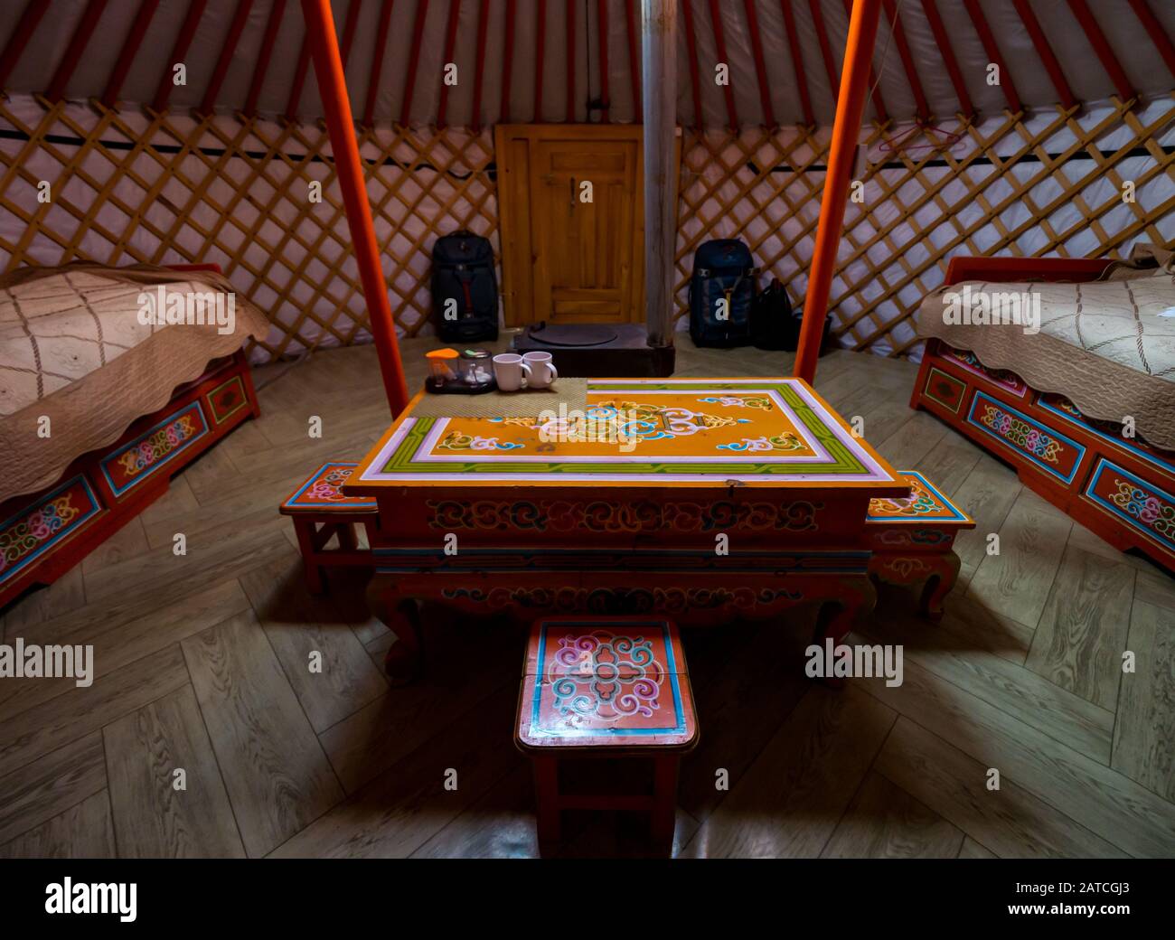 Interior of Mongolian ger or yurt with decorative wooden table & beds, Hustai or Khustain Nuruu National Park, Tov Province, Mongolia, Asia Stock Photo