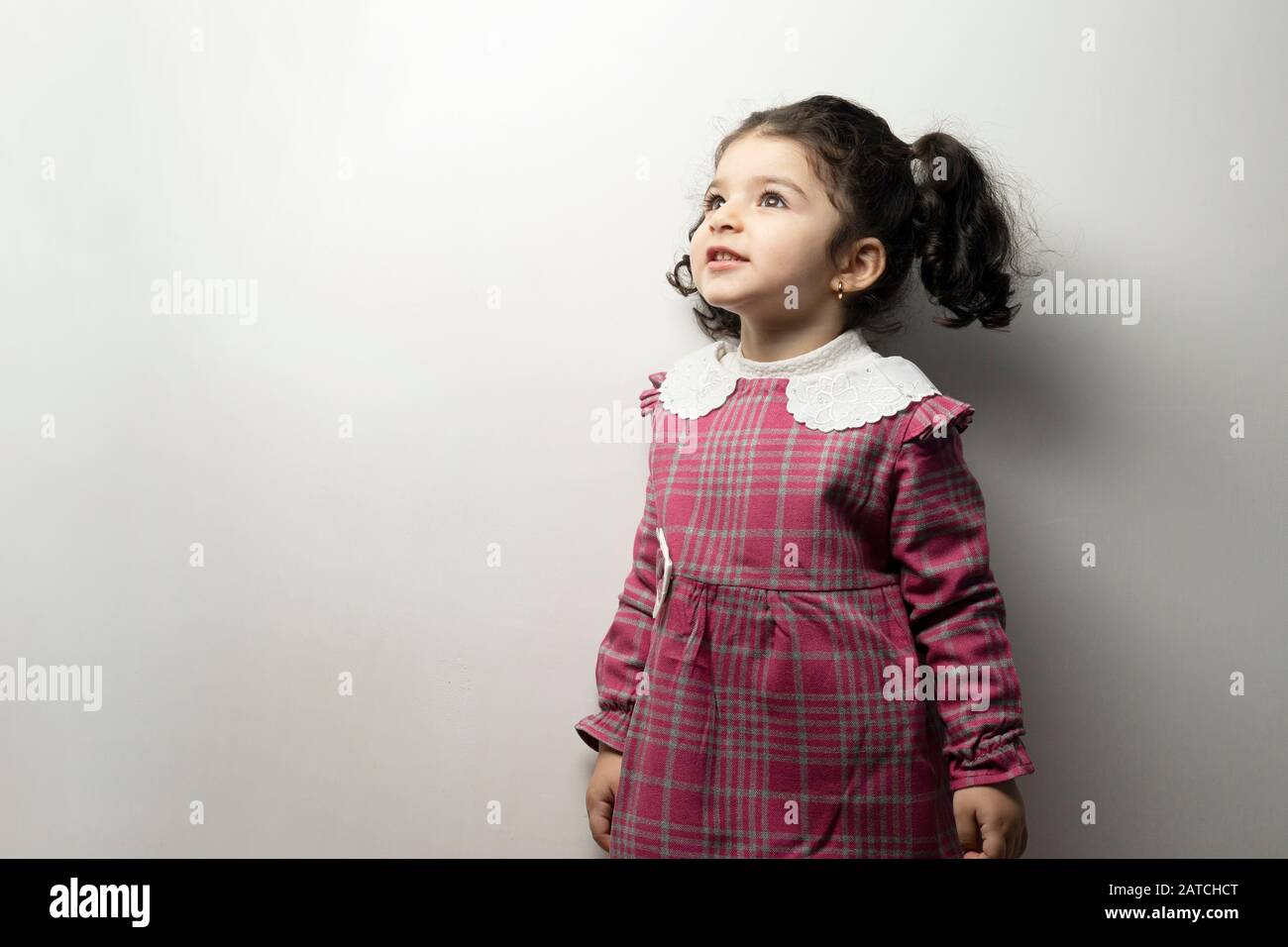 Little girl with side pony hairstyle looking outside of frame, childhood  memories concept Stock Photo - Alamy