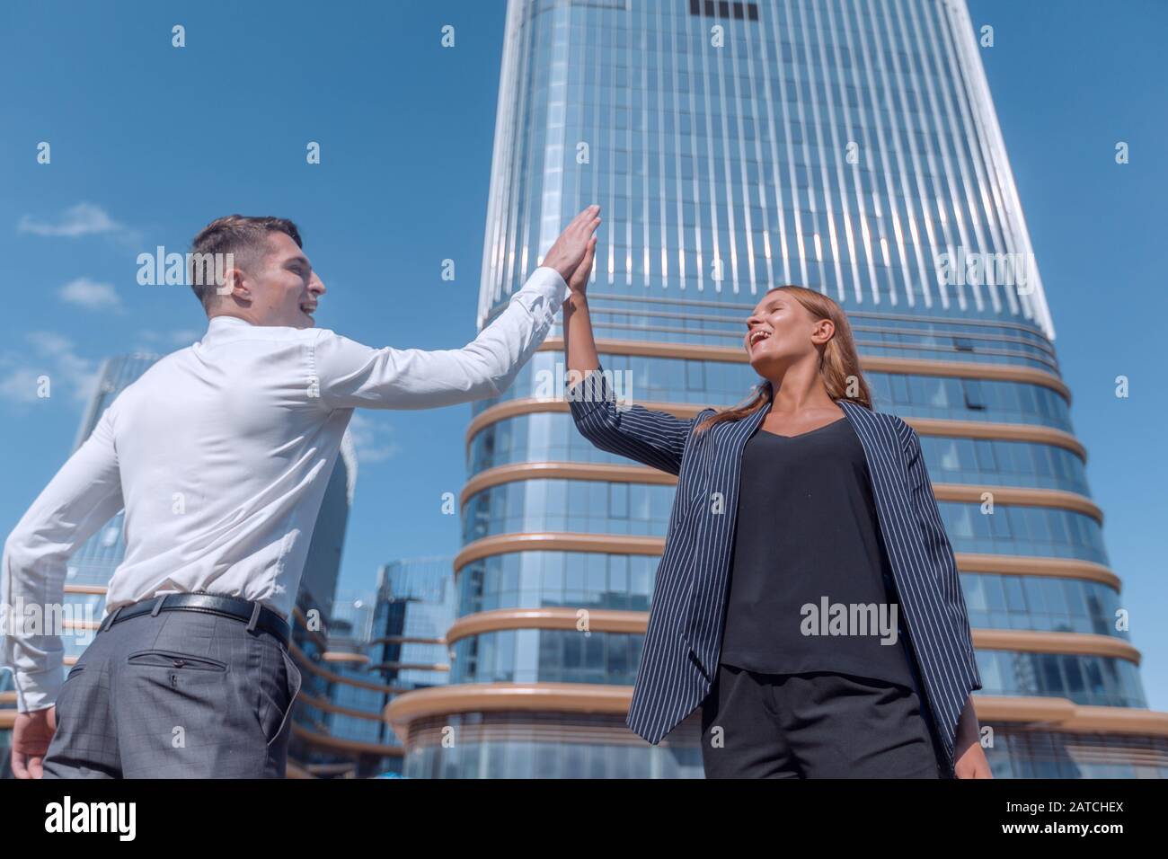 happy business colleagues giving each other a high five Stock Photo - Alamy