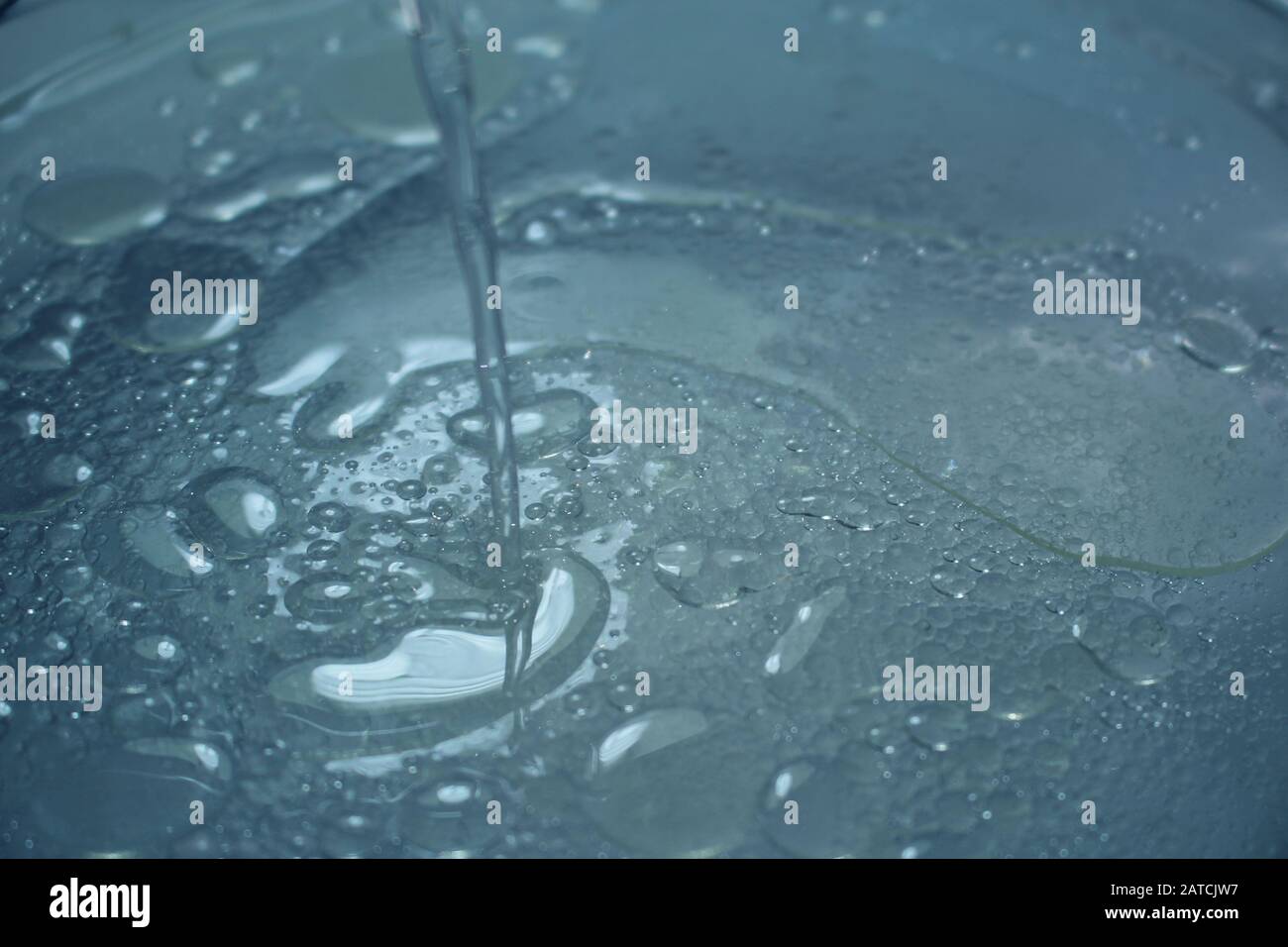 Oil dripping into water Stock Photo - Alamy