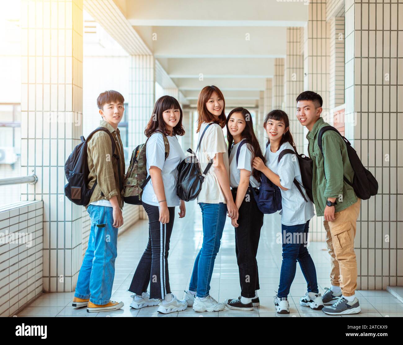 Group of happy students standing on the corridor at college Stock Photo ...