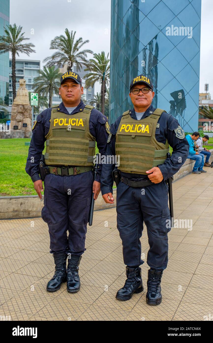 Two Peruvian policemen wearing bulletproof vests posing for a picture, patrolling Parque Alfredo Salazar, Larcomar, Miraflores District, Lima, Peru Stock Photo