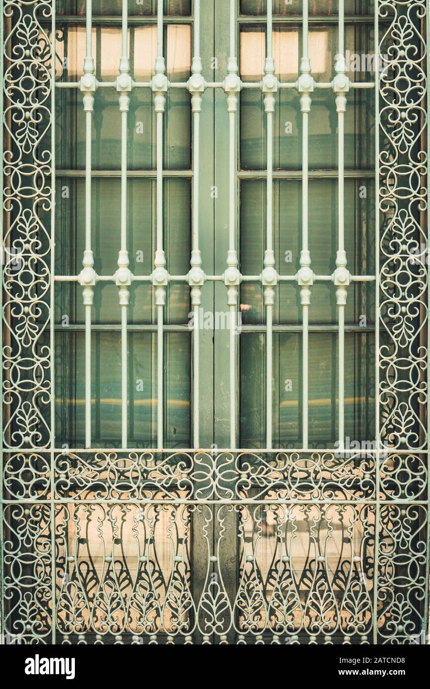 Antique wrought iron window grill Stock Photo