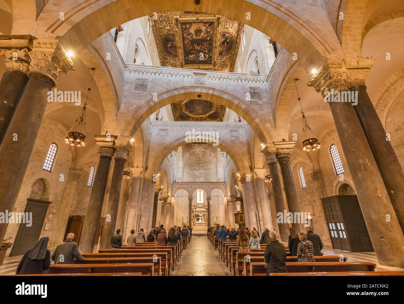 Worshippers at Basilica di San Nicola, 12th century, Romanesque style, in Bari, Apulia, Italy Stock Photo