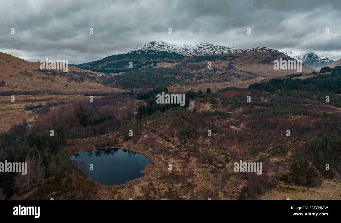 Snowy mountain range in Scottish Highlands at winter - drone point of view Stock Photo