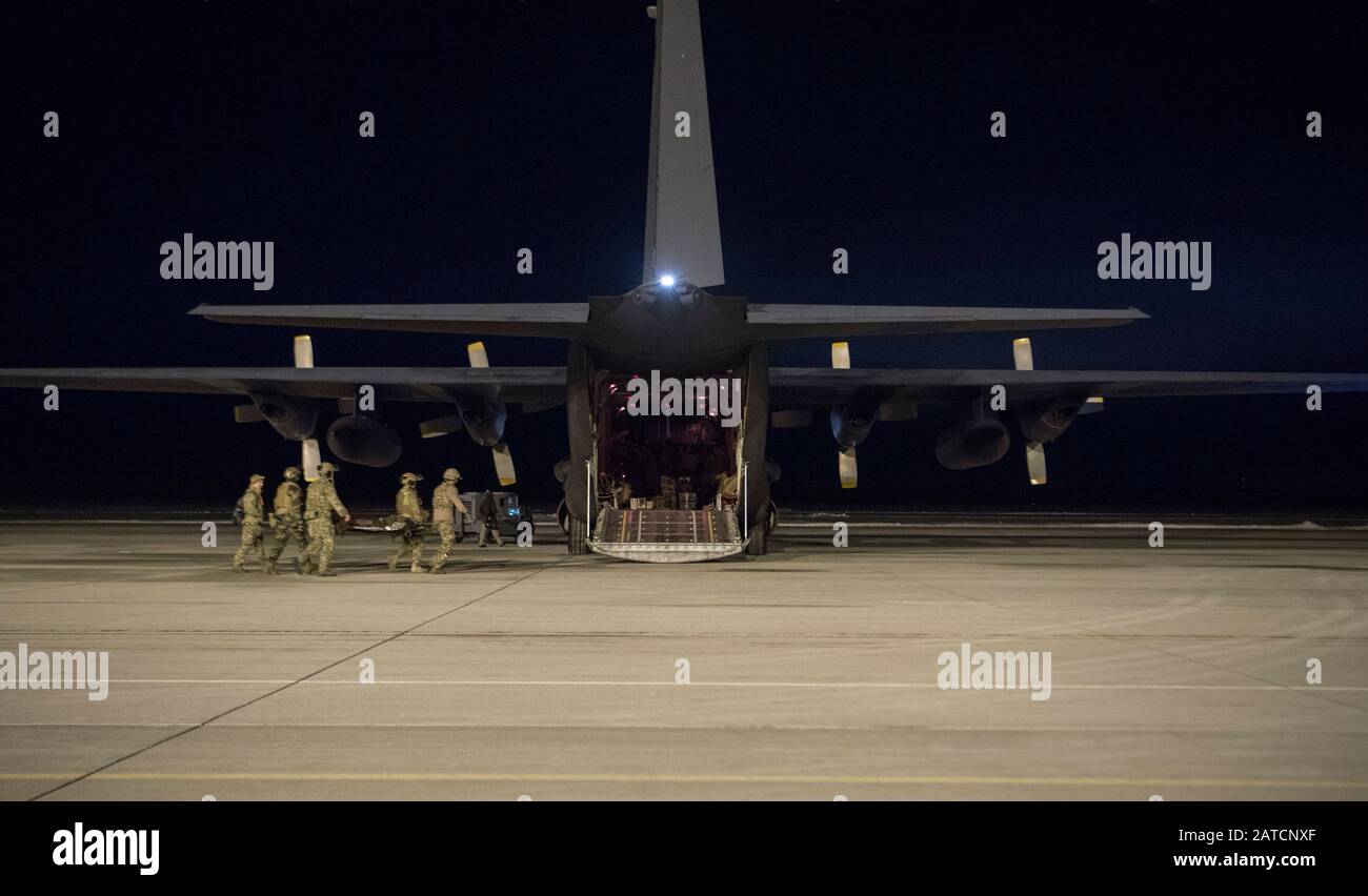 U.S. Air Force combat medics from the 1st Special Operations Support Squadron, use a litter to carry a patient to a French Air Force C-130 during a simulated casualty evacuation scenario at Alpena Combat Readiness Training Center, Michigan in support of Emerald Warrior 20-1 on Jan. 27, 2020. EW 20-1 provides annual, realistic pre-deployment training encompassing multiple joint operating areas to prepare special operations forces, conventional force enablers, partner nations, and interagency elements to integrate with, and execute full spectrum special operations in an arctic climate, sharpenin Stock Photo