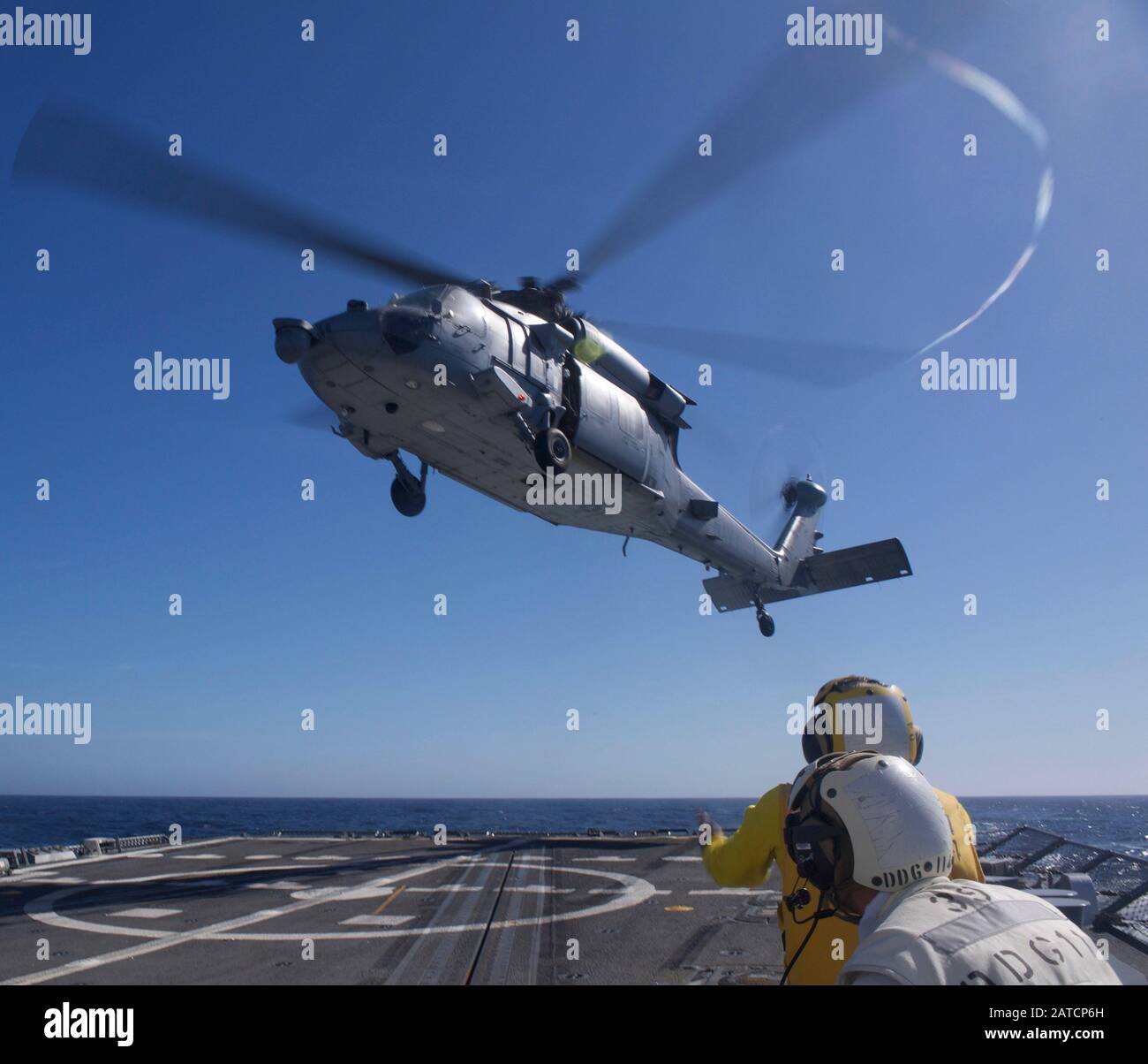 200130-N-FP334-0101   PACIFIC OCEAN (Jan. 30, 2020) A MH-60S Seahawk helicopter, from the 'Indians' of Helicopter Sea Combat Squadron (HSC) 6, lifts from the flight deck aboard the guided-missile destroyer USS Ralph Johnson (DDG 114). Ralph Johnson is currently underway conducting routine operations. (U.S. Navy photo by Mass Communication Specialist 3rd Class Anthony Collier) Stock Photo