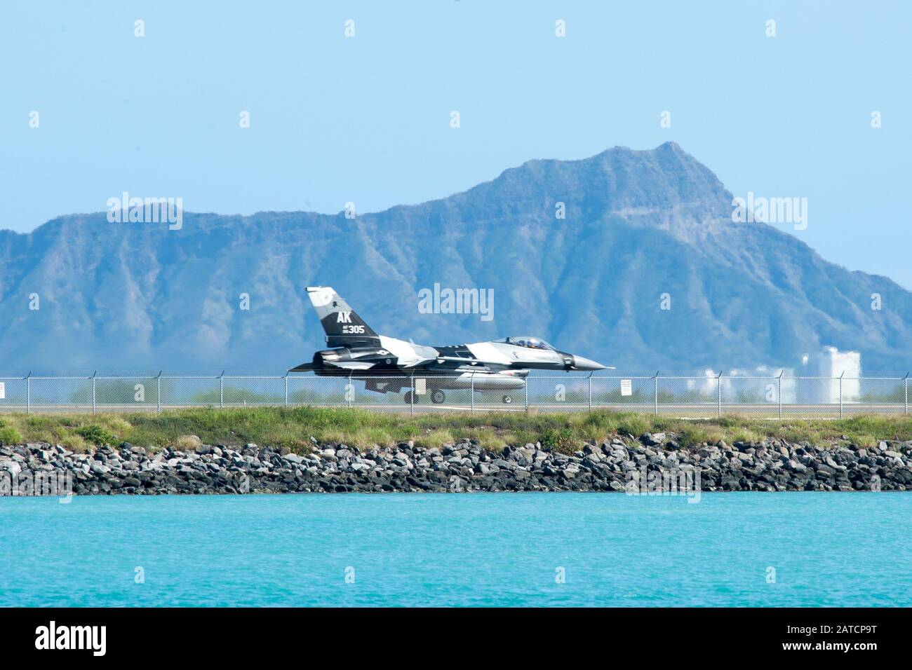 An F-16 Fighting Falcon from the 18th Aggressor Squadron taxis down the Honolulu Airport Runway Jan. 29, 2019. The aircraft practiced combat tactics alongside the world’s most advanced fifth-generation airframes, the F-22 Raptor and F-35A Lightning II. The F-16 is assigned to the 18th Aggressor Squadron in Eielson Air Force Base, Alaska, and its mission is to prepare pilots for victory by simulating combat tactics which are likely to be faced in the event of an air-to-air battle.  (U.S. Air Force photo by Senior Airman John Linzmeier) Stock Photo