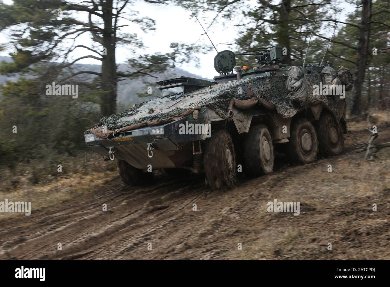 A Dutch GTK Boxer maneuvers through muddy terrain during Combined Resolve XIII at the Hohenfels Training Area in Hohenfels, Germany, Jan. 31, 2020. Combined Resolve XIII is a Headquarters Department of the Army directed Multinational Unified Land Operation exercise with the U.S. Regionally Aligned Force Brigade in support of European Command (EUCOM) objectives. The purpose of the exercise is to prepare the 2nd Armored Brigade Combat Team, 1st Cavalry Division along with 16 other allied and partner nations to fight and win in the European theater. The exercise involves more than 5,000 service m Stock Photo