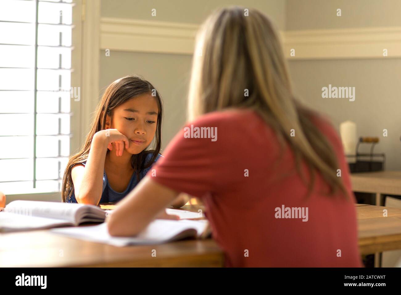 Teacher Helping Her Students With Their Homework School work. Stock Photo