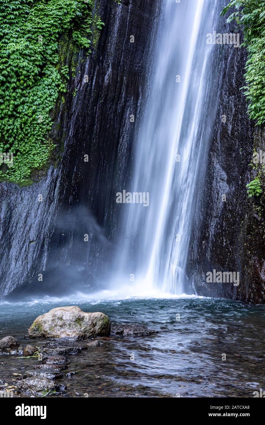 Vertical shot of beautiful waterfalls in air terjun munduk in gobleg indonesia Stock Photo